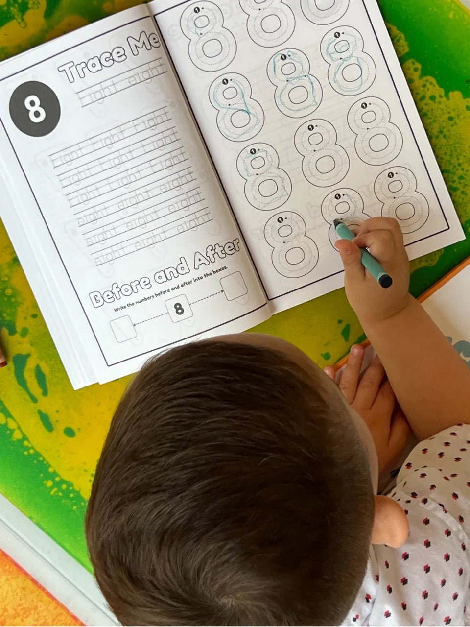Toddler tracing number 8 in 123 Pigments educational activity coloring book