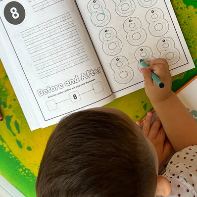 Toddler tracing number 8 in 123 Pigments educational activity coloring book