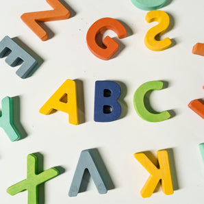 Colorful alphabet letters scattered on a white background