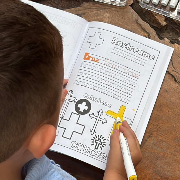 Child coloring the shape cross in spanish from Preschool Essentials Trace Lines, Colors, Shapes and Numbers Coloring Book from Ermenrich Designs. Ages 3 and up.