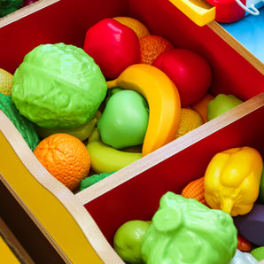 vegetables and fruit toys in a wooden box.